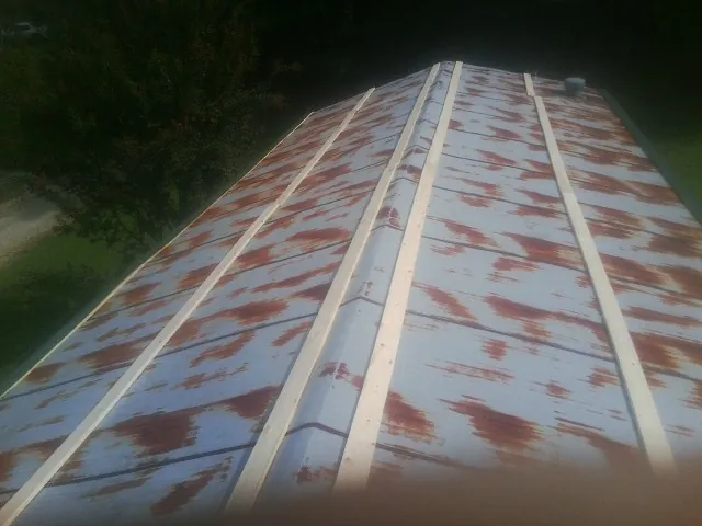 Rusted metal roof panels with new wood purlins before replacement — Storm Damage Roof Repair in Sloughhouse by Roofing Brothers